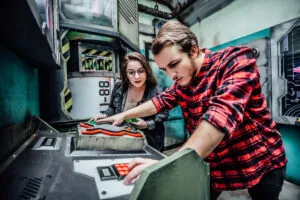 Two people attempt to figure out a puzzle in an escape game.