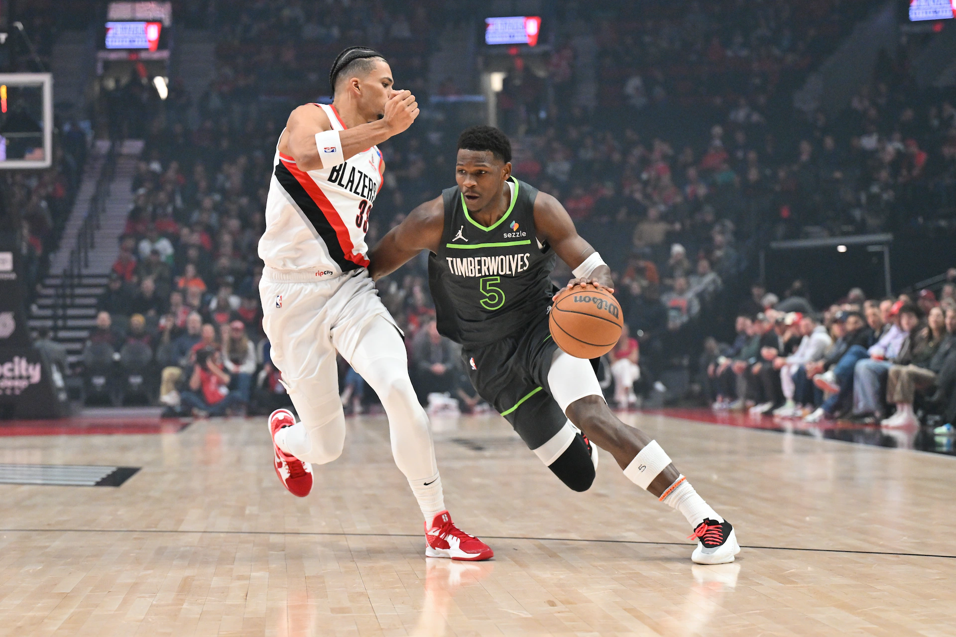 Anthony Edwards dribbles the ball against a Portland Trailblazers player