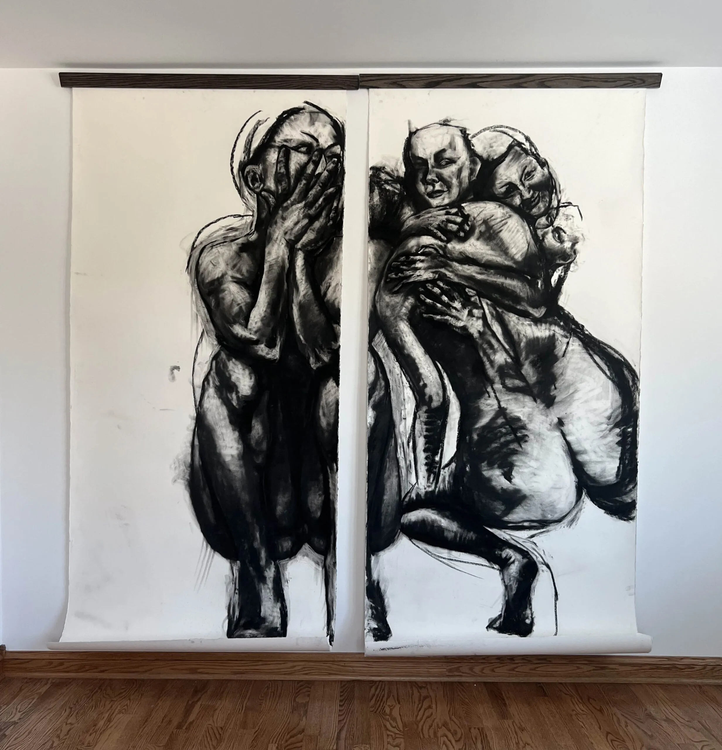 Two tapestries with pencil drawings of people hugging each other