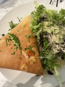 Close up of a crepe with lettuce spilling out