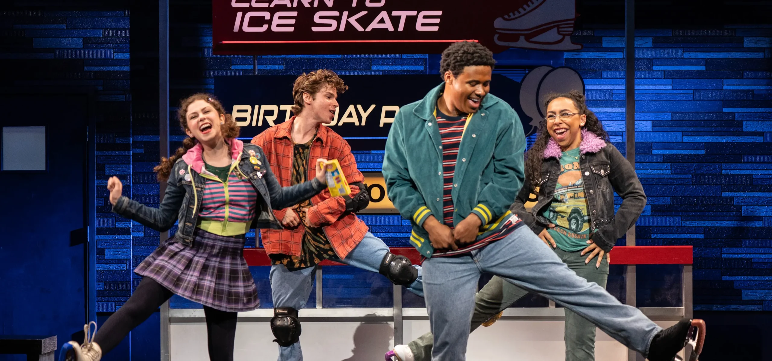 4 teenagers dressed in 80s clothing dance while wearing ice skates