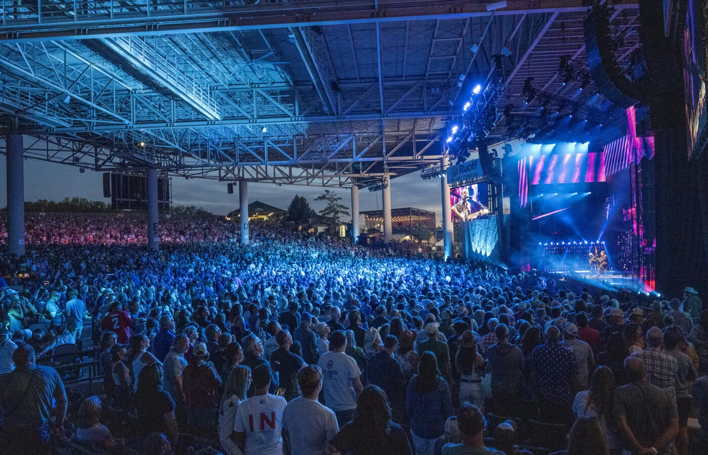 Crowd watches a musician perform on stage