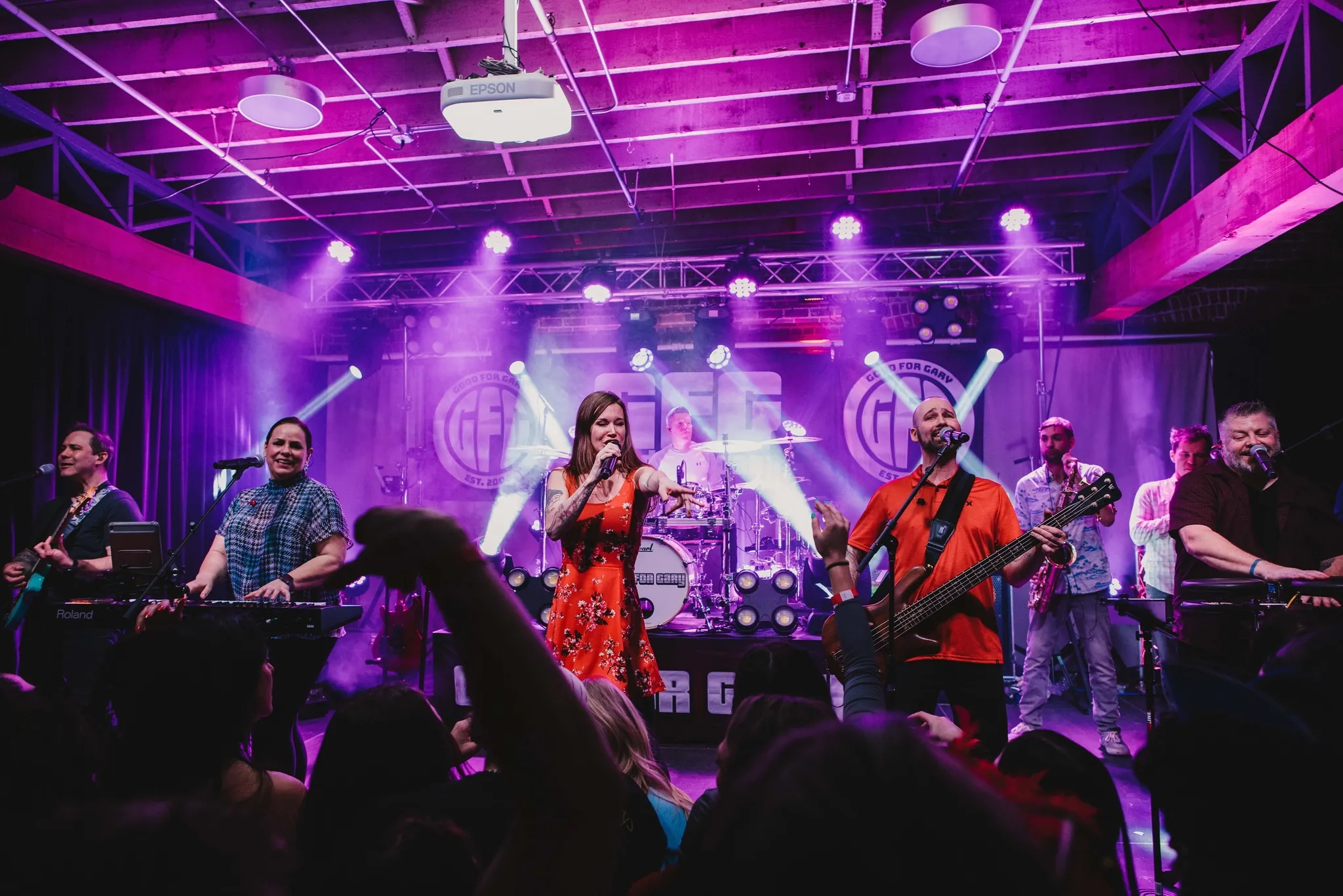 A band sings and plays instruments on stage