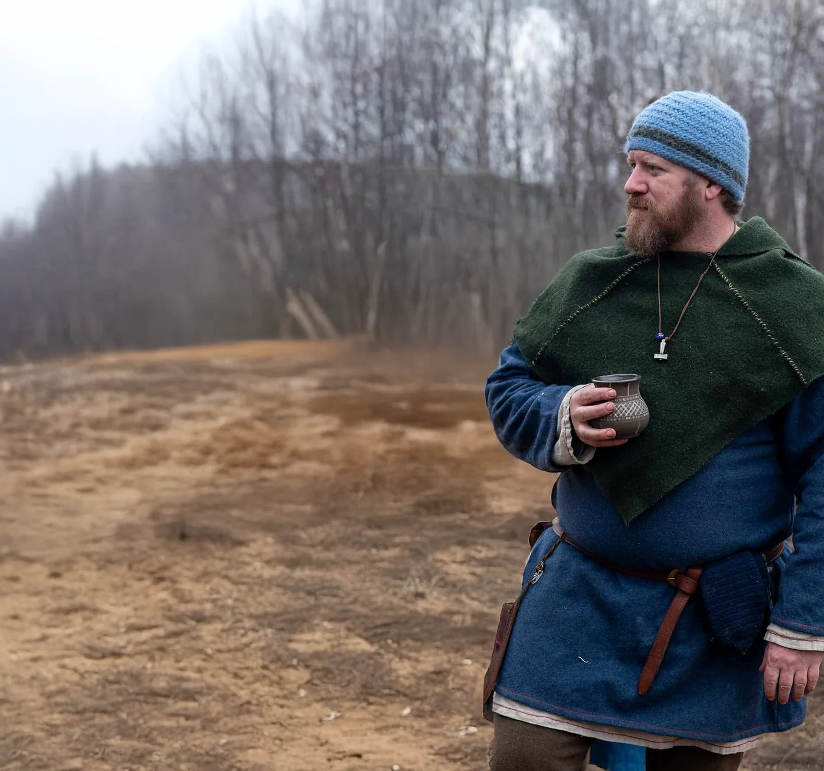 A man in traditional Irish attire stares into the distance