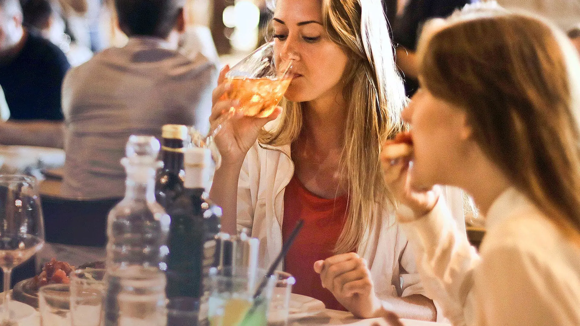 A woman enjoys a cocktail
