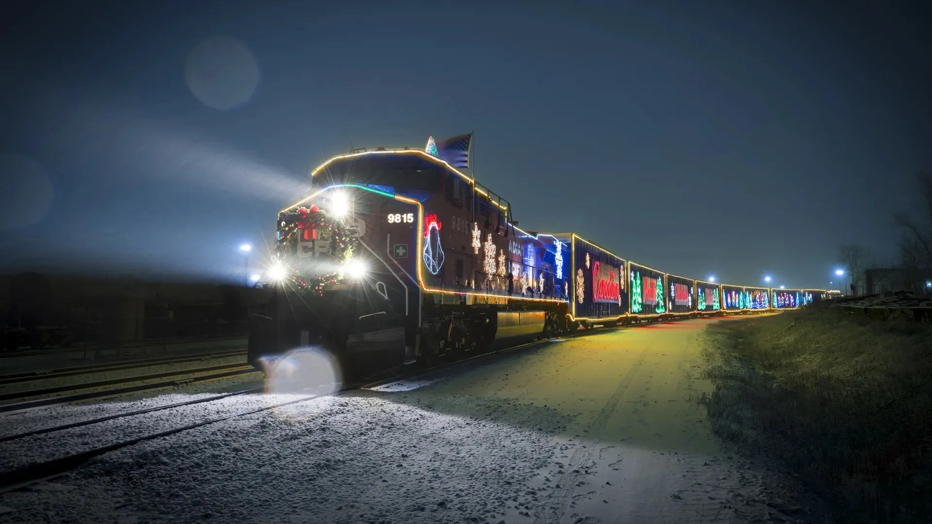 The Candian Pacific Holiday Train making its annual trek. A train decorated with holiday lights traveling in the snow.